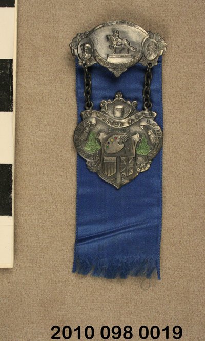 Pewter pin with blue ribbon from the International Association of Master House Painters and Decorators Convention held in St. Louis in 1911 by Unknown
